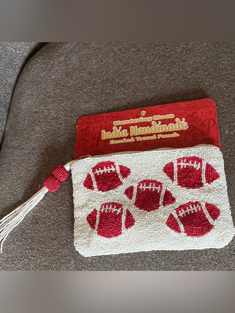 Handmade White Beaded Travel Pouch with Red Football Motifs